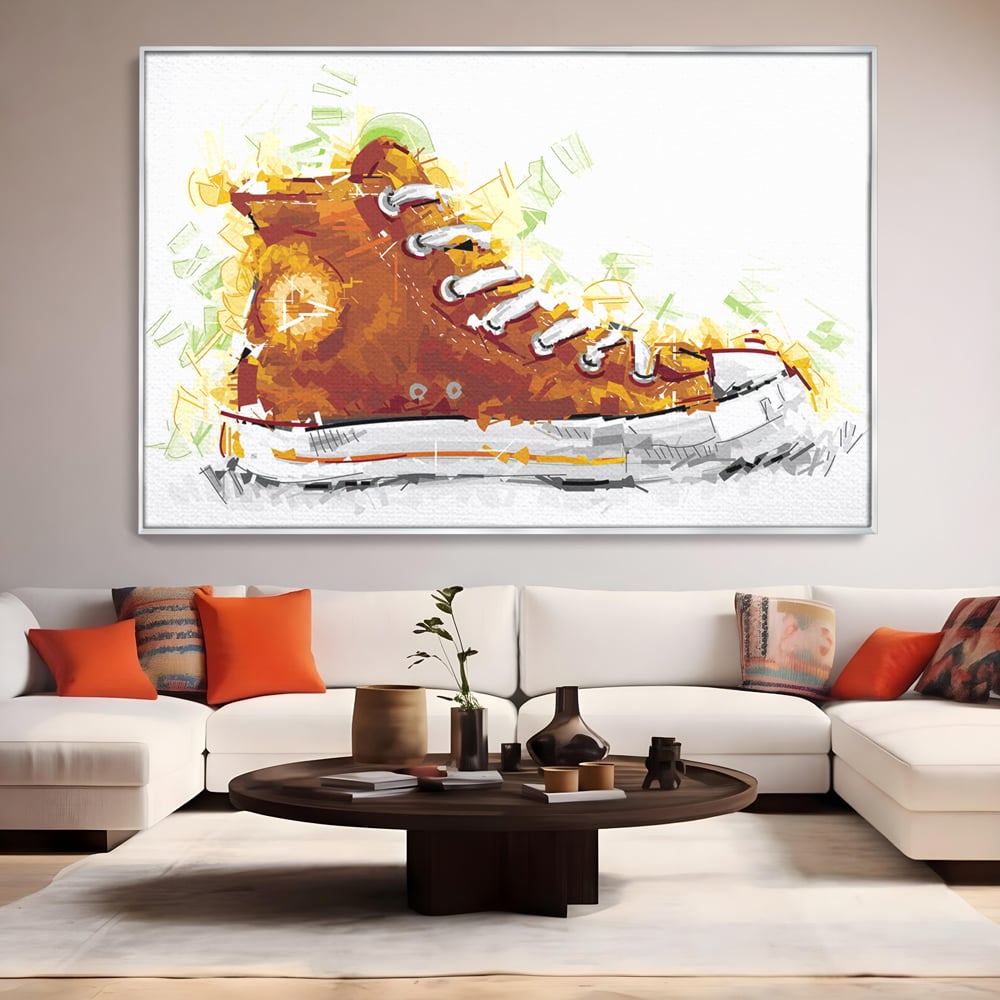 Tablou canvas cu tablou canvas cu tenisi portocalii, in rama de aluminiu argintiu, pe perete intr-un living